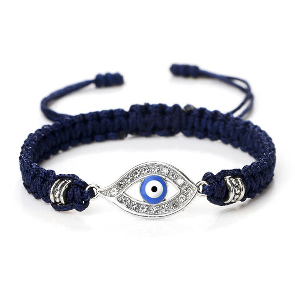 Navy blue cord evil eye bracelet with silver blue evil eye crystal charm on white bg
