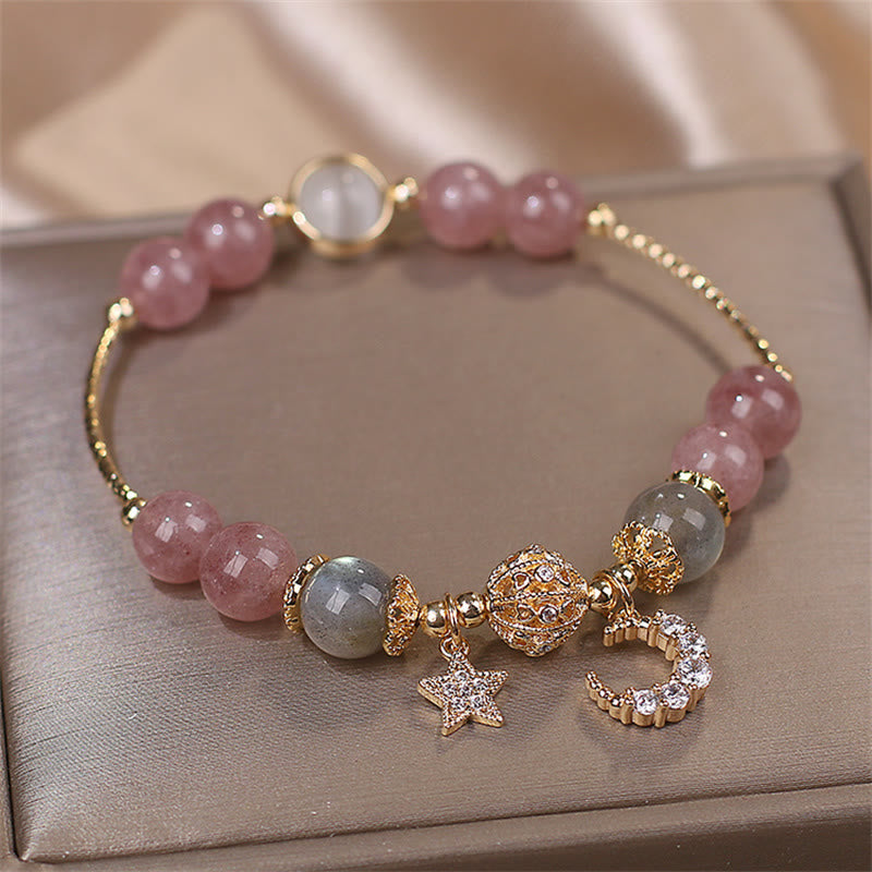 Strawberry Quartz moon star bracelet with pink quartz beads, gray moonstone accents, gold filigree focal bead, pavé crystal moon and star charms.