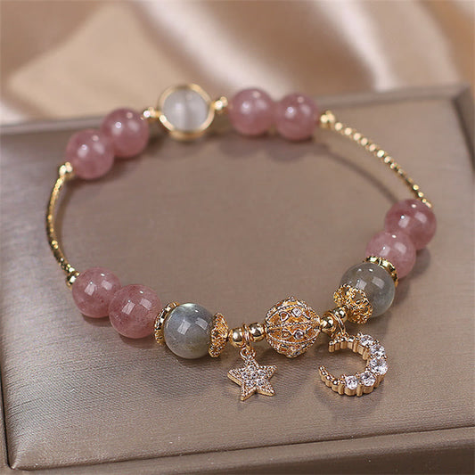 Strawberry Quartz moon star bracelet with pink quartz beads, gray moonstone accents, gold filigree focal bead, pavé crystal moon and star charms.