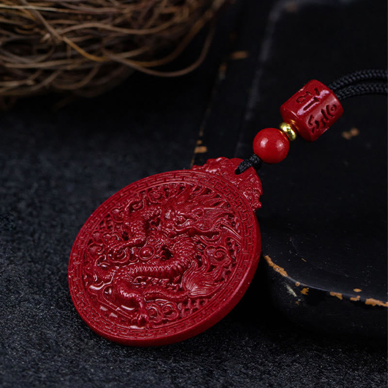 Cinnabar Dragon Pendant – Carved dragon amulet displayed with lacquerware dish and dried roots, Artisan