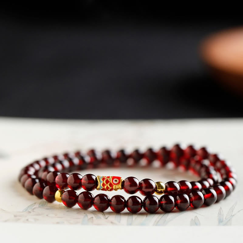 999 Gold Koi Fish Bracelet – sunset warm tone photo, garnet glow, gold koi fish wealth amulet