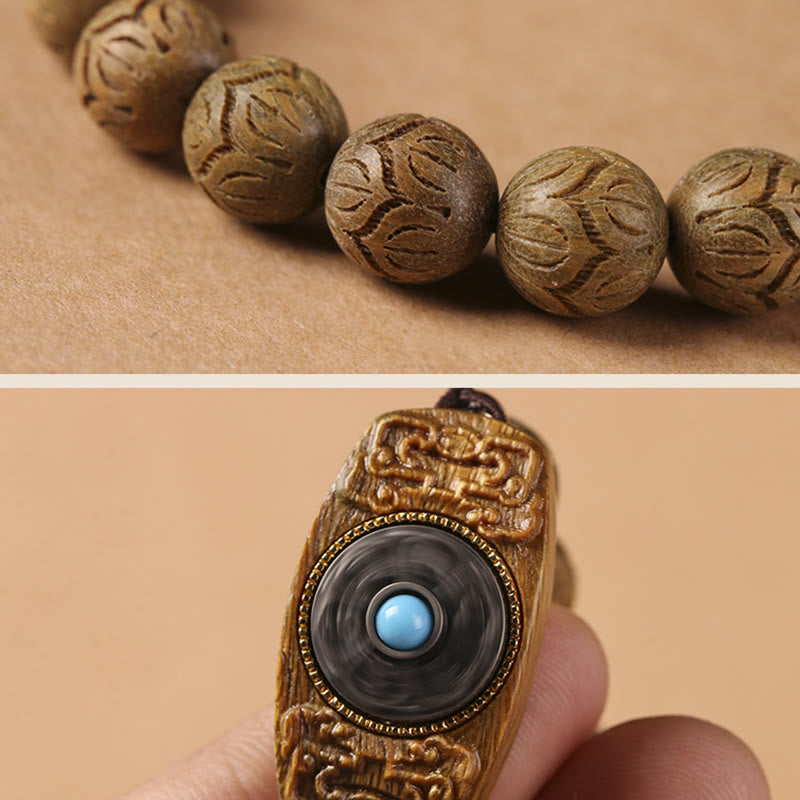 Green Sandalwood & Ebony Soothing Bracelet – macro detail of lotus carved beads and prayer wheel charm with turquoise ston...