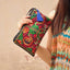Dragon Butterfly Embroidery Wallet - 3/4 view of dragon clutch with blue tassel, Transformation