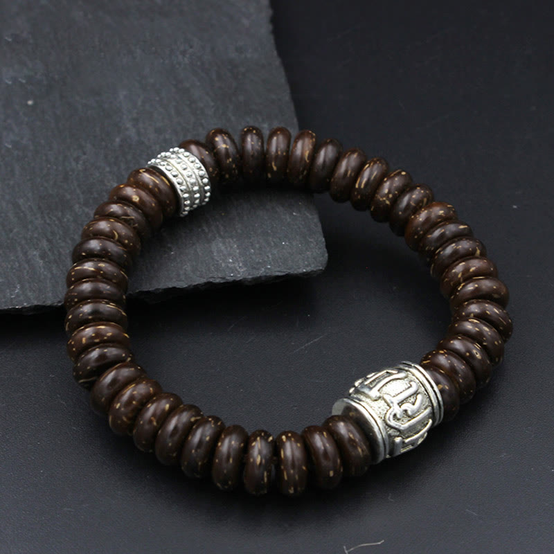 Om Mani Padme Hum Coconut Shell Bracelet – three-quarter view on dark surface, full loop