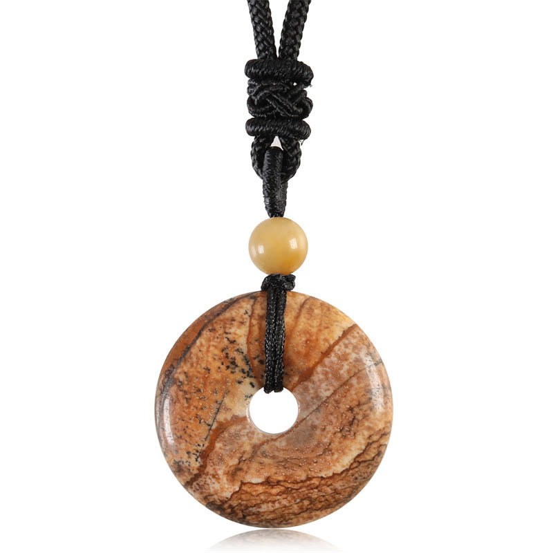 Lucky Coin Pendant Healing Crystal Gemstone Necklace – Reddish-orange carnelian pi disc pendant with dark inclusions on black cord