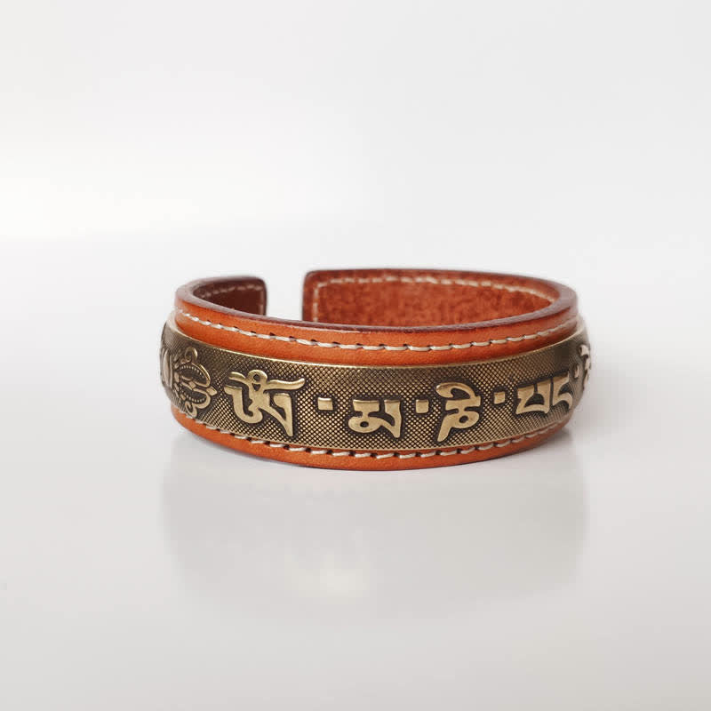 Om Mani Padme Hum Dragon Phoenix Bracelet - Low angle view of leather brass cuff with Tibetan script, Serenity