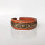 Om Mani Padme Hum Dragon Phoenix Bracelet - Low angle view of leather brass cuff with Tibetan script, Serenity