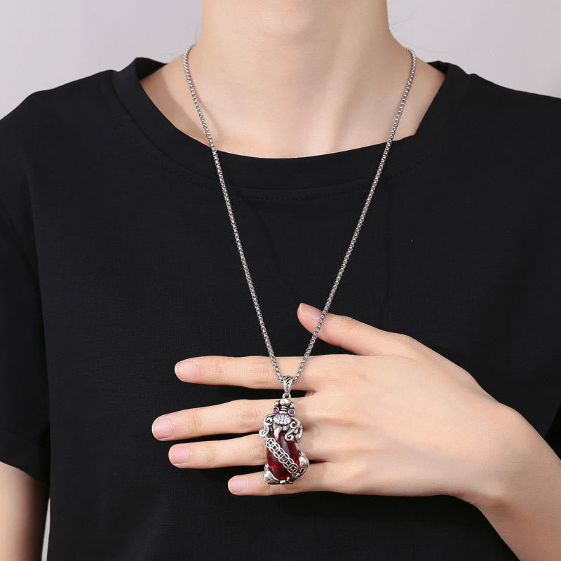 Garnet PiXiu Necklace – Model wearing PiXiu necklace with black t-shirt hand on chest, statement jewelry