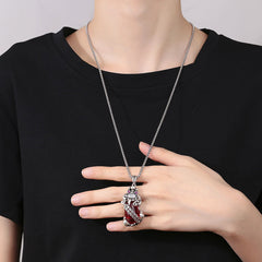 Garnet PiXiu Necklace – Model wearing PiXiu necklace with black t-shirt hand on chest, statement jewelry