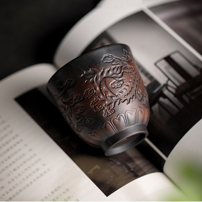 Ceramic Tea Cup – Pine tree carving resting on open book, scholarly gongfu tea aesthetic