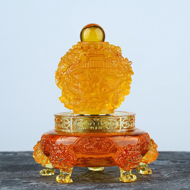 Amber Liuli Dragon Ornament – Golden crystal sphere with dragon and pagoda on dark stone, Wealth