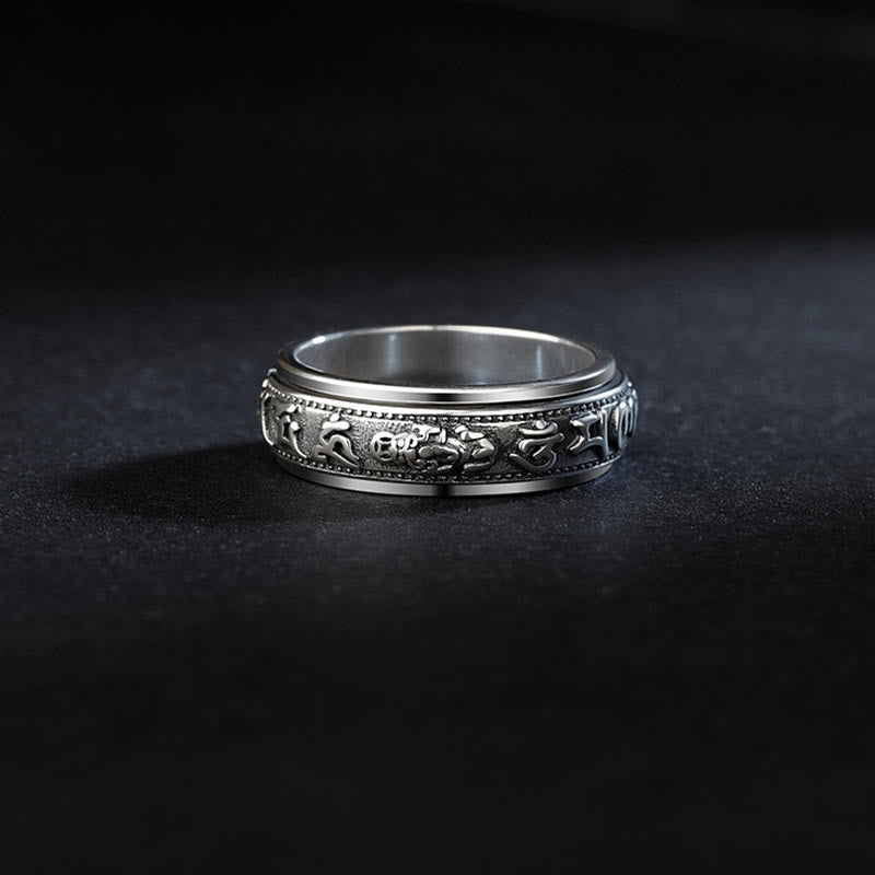 Tibetan PiXiu Ring – Side view of silver spinner ring on black, mantra band