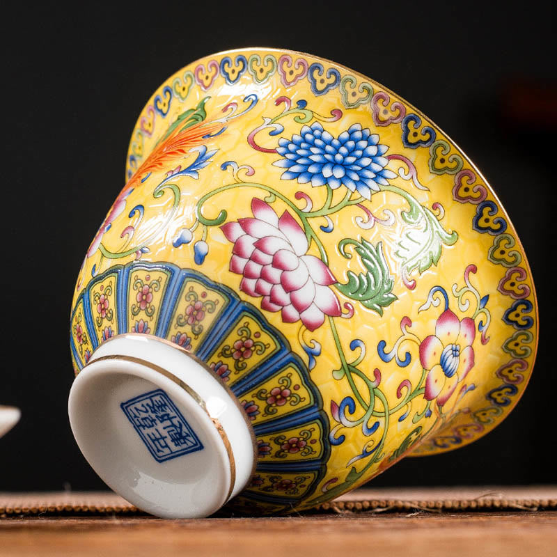 Dragon Phoenix Flower Gaiwan Tea Set – Yellow phoenix cup tilted to show base seal mark, lappet border on wood