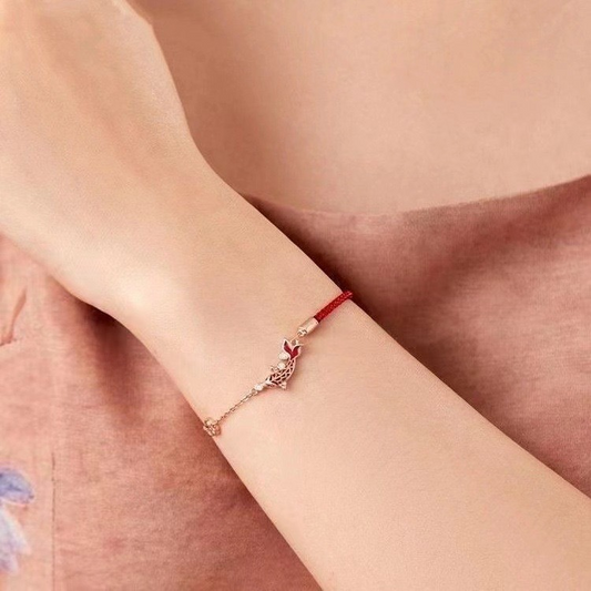 Shang An Koi Anklet – red string and rose gold chain worn on wrist, delicate koi charm with crystals, elegant accessory