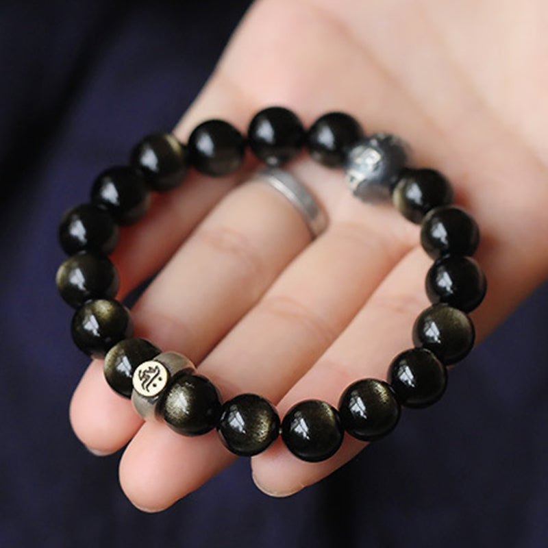 Zodiac Natal Buddha Obsidian Silver Bracelet - Displayed on hand with crystal accent bead, golden luster