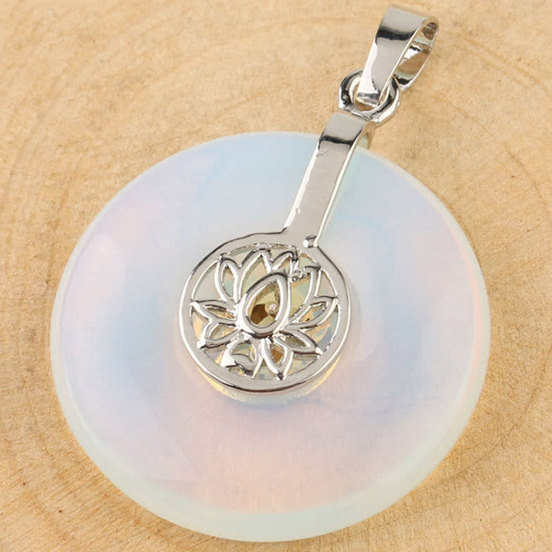 Crystal Amethyst Pink Crystal Lotus Necklace – Opalite lotus donut pendant overhead view on wood, ethereal glow and silver filigree detail