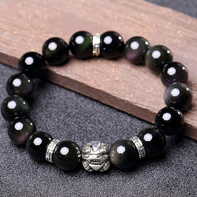 Rainbow Obsidian Bracelet – On wood plank with silver spacer beads, dark iridescent stones