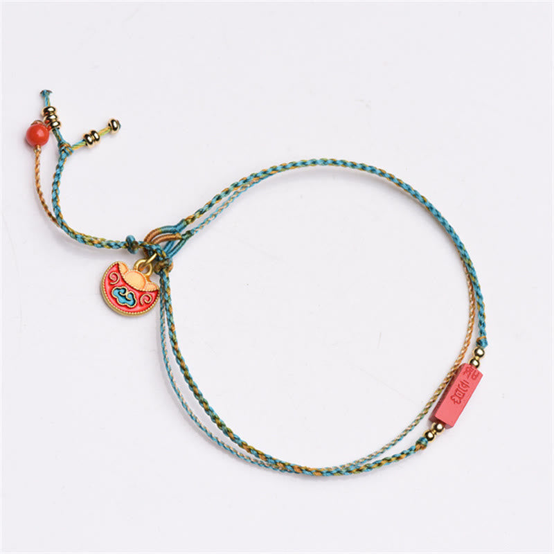 Cinnabar Bracelet - Double layer braided cord with cloud motif pendant, white background