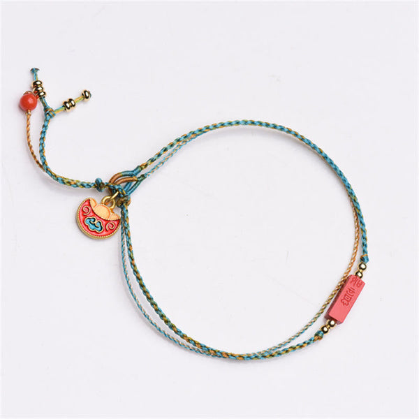 Cinnabar Bracelet - Double layer braided cord with cloud motif pendant, white background