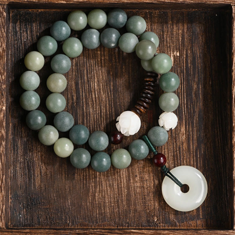 Cyan Bodhi Seed Jade Peace Buckle Bracelet - double-loop beads with peace buckle pendant in dark wood tray