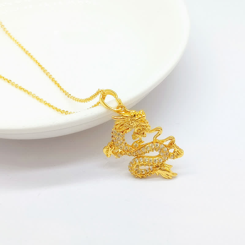 Gold Dragon Protection Necklace – Dragon pendant ascending from white dish rim, sparkling stones, Fortune