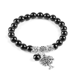 Tree of Life black onyx bracelet with glossy black gemstone beads, silver Tree of Life charm, ornate silver spacers and black bead dangle.