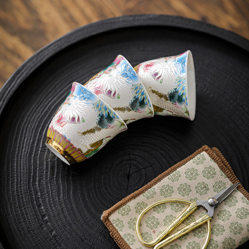 Dragon Phoenix Ceramic Teacup - Three tilted cups on charred wood tray with scissors, Delicate craft