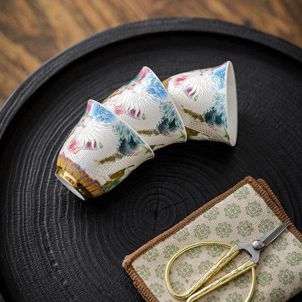 Dragon Phoenix Ceramic Teacup - Three tilted cups on charred wood tray with scissors, Delicate craft