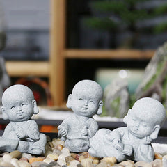 Meditation Monk Statue - Three adorable monk figurines arranged on decorative pebbles