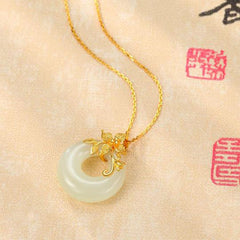 Tibetan White Jade Calm Necklace - macro on calligraphy backdrop with gold flower, jade necklace