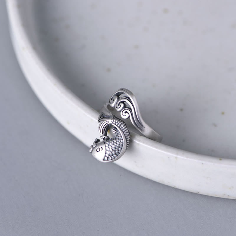 925 Sterling Silver Koi Ring – three-quarter view showing dimensional koi relief with water splash details, silver