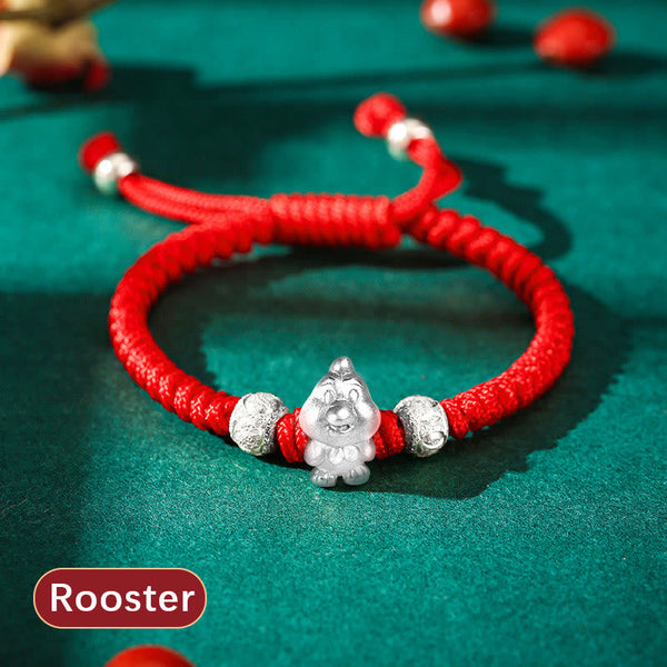 999 Sterling Silver Zodiac Red Rope Kids Bracelet - Silver dog charm on red cord on teal fabric, cute zodiac accessory