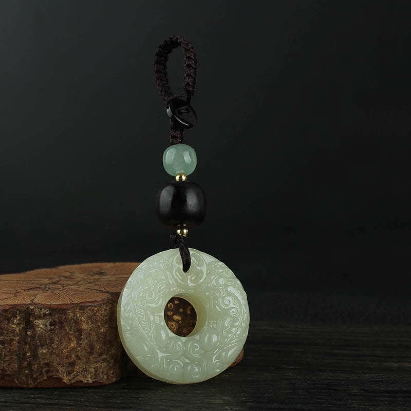 Jade PiXiu Peace Buckle Abundance Key Chain – Close-up braided cord with black green beads on wood texture detail