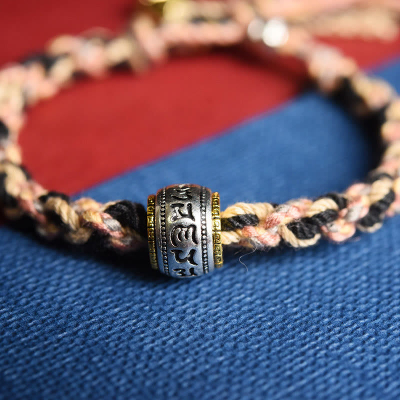 Zakiram Goddess Bracelet – Macro detail of engraved mantra cylinder bead with gold rings, spiritual jewelry
