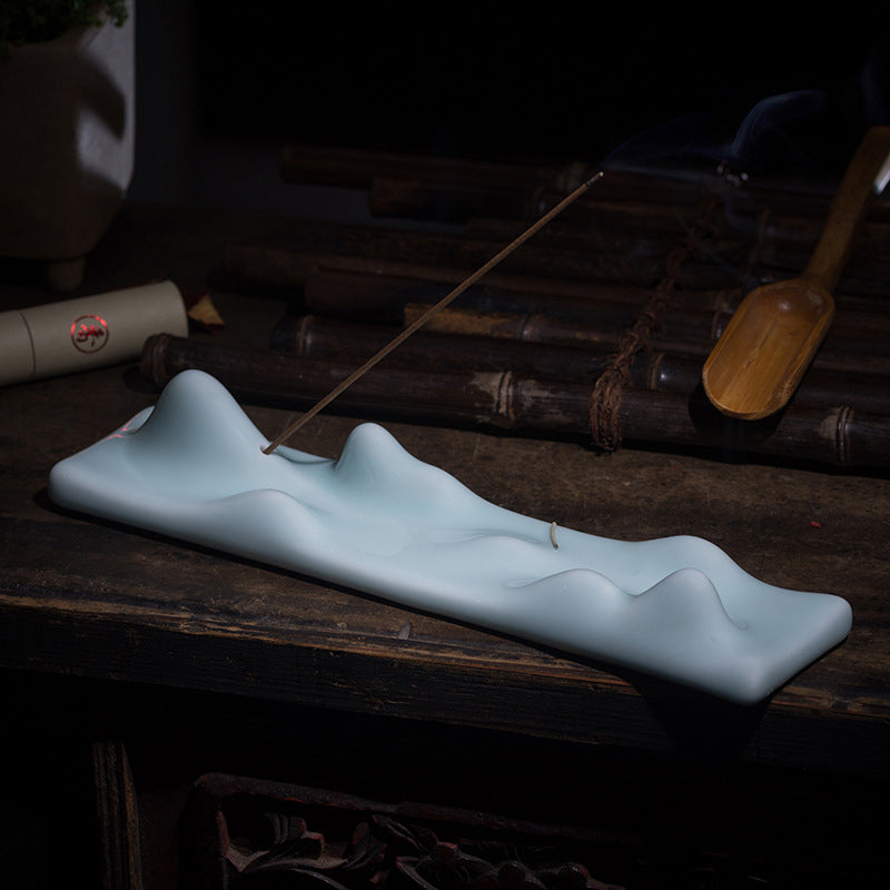 Mountain Incense Burner – Celadon peaks on dark wood with ash, zen ambiance