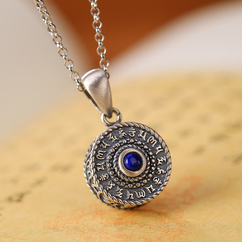 Om Mani Padme Hum Pendant – Angled view with lapis stone and mantra script on warm parchment, Buddhist jewelry Imagen principal del producto