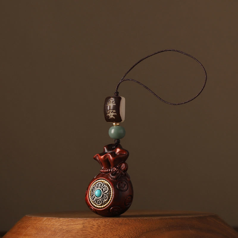 Sandalwood Money Bag Mantra Hanging - Dark red bag with turquoise medallion, protection charm