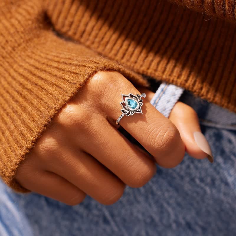 Sterling Silver Lotus Ring – Blue zircon lotus ring worn on hand with knit sweater, blessing jewelry
