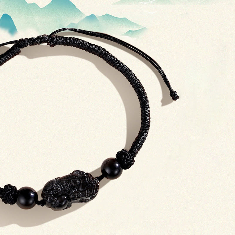 Silver Sheen Obsidian Bracelet – Close-up black bracelet with mountain illustration