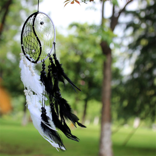 Yin Yang Dream Catcher with Feathers – Outdoor dreamcatcher with feather tassels in nature, spiritual decor