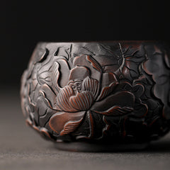Ceramic Tea Cup – Elevated angle of floral relief, terracotta petals on charcoal clay, gongfu tea