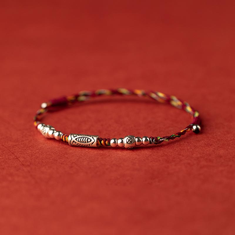 925 Koi Braided Bracelet - close-up silver koi fish pendant, vibrant braided string band, fortune
