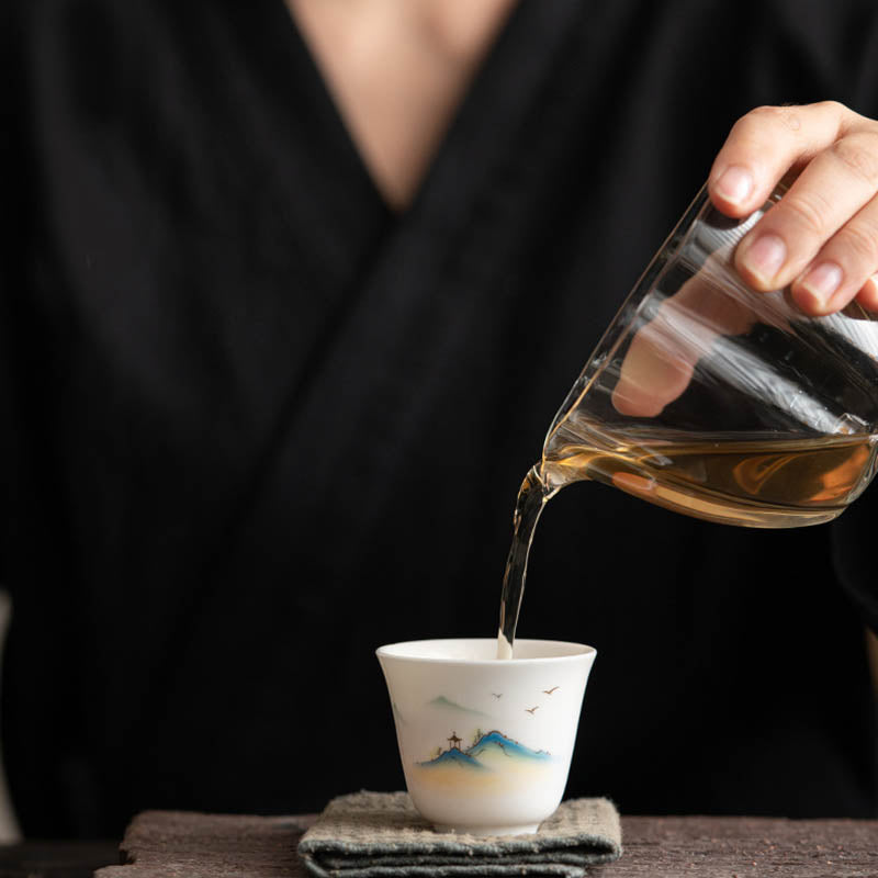 Ceramic Kung Fu Tea Cup – tea pouring moment with amber stream, mountain-pavilion decoration, zen ritual, mindful