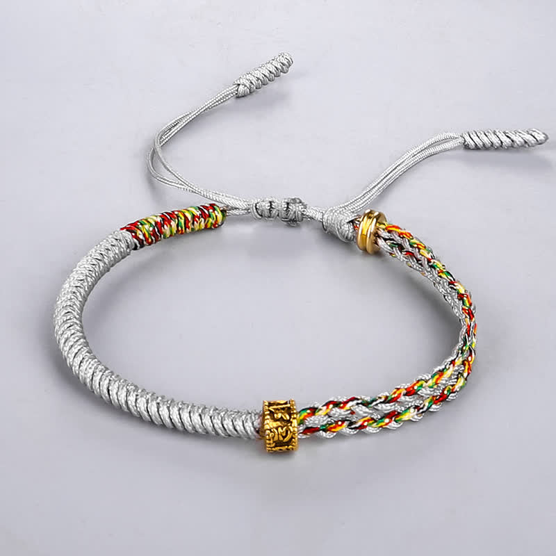 Om Mani Padme Hum Red String Bracelet – Silver-gray braided rope with red yellow green multi-color woven bands and gold engraved charm bead on white