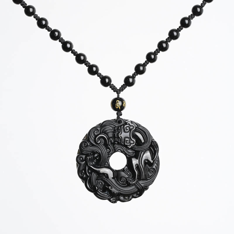 Black Obsidian Pixiu Pendant – Pendant on black beaded cord against clean white background