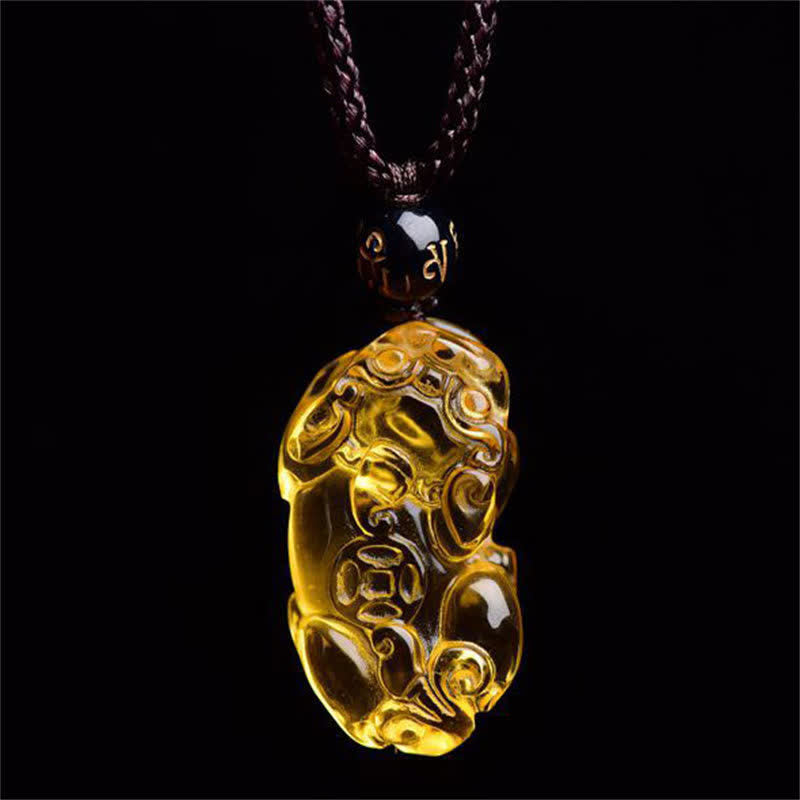 Citrine PiXiu Necklace Pendant – Glowing citrine PiXiu pendant against black background, luminous charm