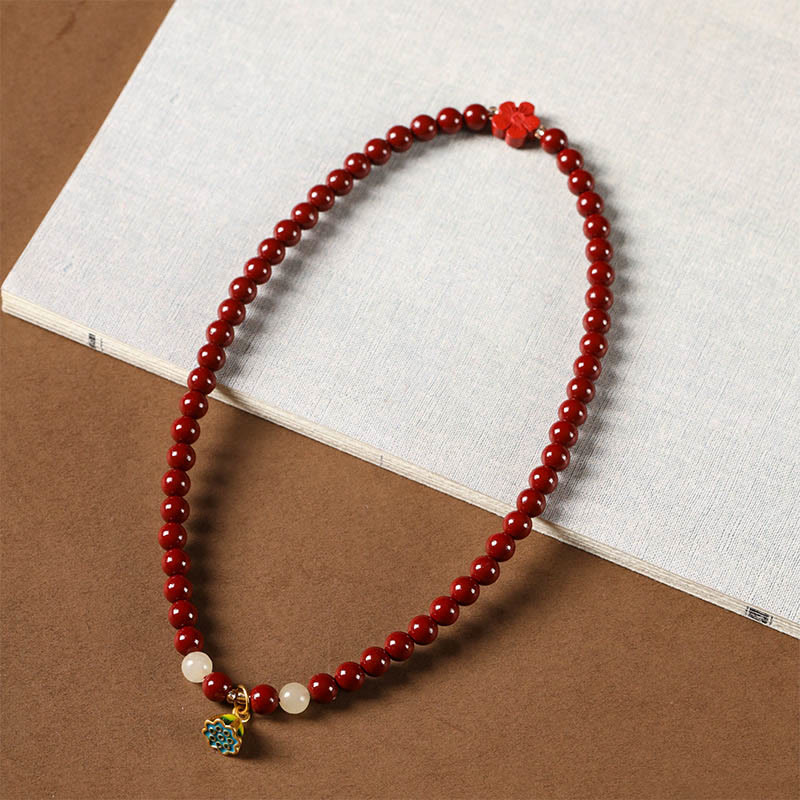 Cinnabar Lotus Bracelet – looped drape on fabric with lotus pod pendant, red beads
