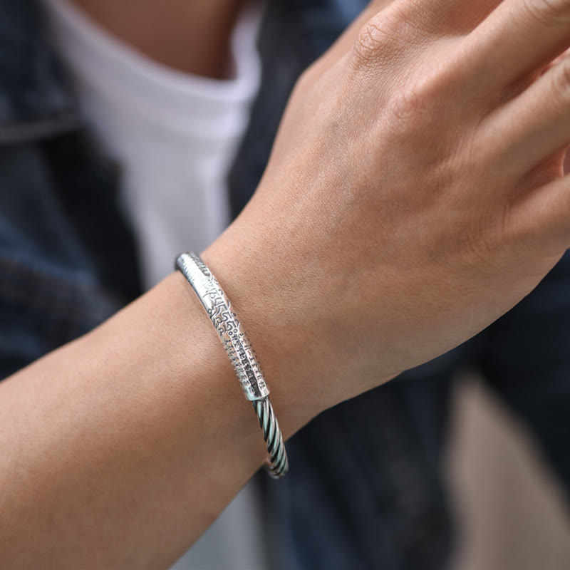 Tibetan Heart Sutra Cuff Bracelet – worn on wrist with casual denim and white tee, silver spiritual jewelry
