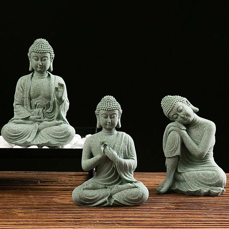 Green Sandstone Buddha Statue – Three seated Buddha figures in serene poses on wood, studio