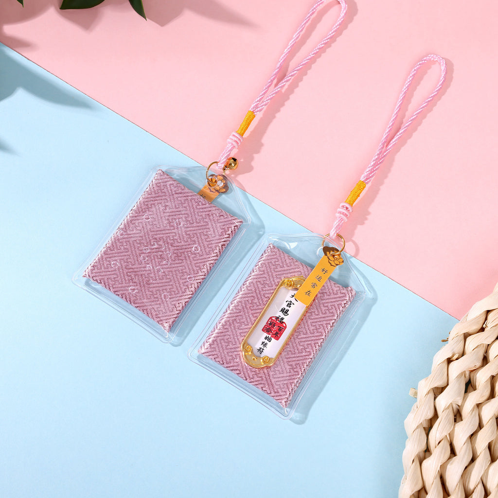 Two pink marriage blessing amulets on pink and blue background